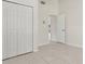 Bedroom featuring tile floors, large closets, and white doors, creating a clean and organized space at 2933 Birmingham Blvd, Orlando, FL 32829