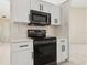 Updated kitchen features white cabinets, modern appliances, and ample counter space at 2933 Birmingham Blvd, Orlando, FL 32829