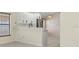 Open kitchen area with white cabinets, stainless steel appliances, and tile flooring for a modern look at 2933 Birmingham Blvd, Orlando, FL 32829