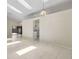 Open living room with bright interior, tiled flooring, natural lighting, and a view into the modern kitchen at 2933 Birmingham Blvd, Orlando, FL 32829