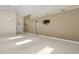 Bright, open living room featuring neutral tones, tile floors, and a skylight offering natural light at 2933 Birmingham Blvd, Orlando, FL 32829