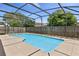 Screened-in pool with a clear blue water, concrete deck, surrounded by mature trees, creating a private oasis at 2933 Birmingham Blvd, Orlando, FL 32829
