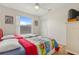 Bedroom with two twin beds, a ceiling fan, and a large window for natural light at 3018 Bransbury Ct, Kissimmee, FL 34747
