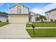 Charming two-story home with a well-maintained lawn and a two-car garage at 3018 Bransbury Ct, Kissimmee, FL 34747