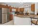 Bright kitchen featuring stainless steel appliances, granite countertops, and wooden cabinets at 3018 Bransbury Ct, Kissimmee, FL 34747