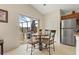 Sunny breakfast nook features table, seating, and stainless-steel appliances at 3018 Bransbury Ct, Kissimmee, FL 34747