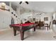 Open-concept living room featuring a pool table, high ceilings, and lots of light at 3018 Bransbury Ct, Kissimmee, FL 34747