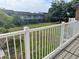 View from a fenced back deck overlooking a shared green space with mature trees and apartment buildings at 3057 Aaron Burr Ave # 2, Winter Park, FL 32792