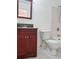 Bathroom featuring a dark vanity, toilet, and a shower with white tiling at 3057 Aaron Burr Ave # 2, Winter Park, FL 32792