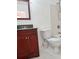 Bathroom featuring a dark vanity, toilet, and a shower with white tiling at 3057 Aaron Burr Ave # 2, Winter Park, FL 32792
