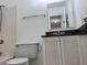 A bathroom featuring a shower and tub combination, toilet, and vanity with dark countertop at 3057 Aaron Burr Ave # 2, Winter Park, FL 32792