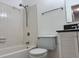 A bathroom with a white tiled shower and tub combination, toilet, and vanity with granite countertop at 3057 Aaron Burr Ave # 2, Winter Park, FL 32792