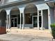 Building entrance featuring elegant arched entryways, sturdy support columns, and clear glass doors at 3057 Aaron Burr Ave # 2, Winter Park, FL 32792