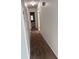 Hallway with a long closet leading to a bathroom, featuring brown carpet at 3057 Aaron Burr Ave # 2, Winter Park, FL 32792