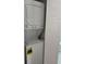 White stacked washer and dryer in an alcove, with access door with louvered slats at 3057 Aaron Burr Ave # 2, Winter Park, FL 32792