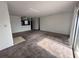 Spacious living room with plush carpet, neutral walls, and an adjacent kitchen area at 3057 Aaron Burr Ave # 2, Winter Park, FL 32792