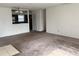 Spacious living room with plush carpet, neutral walls, and an adjacent kitchen area at 3057 Aaron Burr Ave # 2, Winter Park, FL 32792