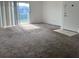 Cozy living room featuring neutral carpet, access to a balcony, and ample natural light at 3057 Aaron Burr Ave # 2, Winter Park, FL 32792