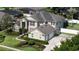 Spacious home featuring a well-manicured lawn, mature trees, and an attached two-car garage at 325 Green Ash Ln, Sanford, FL 32771