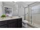 Bright bathroom featuring tile flooring, a vanity sink, toilet, and a glass enclosed shower at 325 Green Ash Ln, Sanford, FL 32771