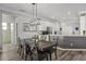 Open dining area adjacent to a modern kitchen with ample counter space and seating for six at 325 Green Ash Ln, Sanford, FL 32771