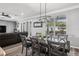 Stylish dining room featuring a modern light fixture, large windows, and seating for six at 325 Green Ash Ln, Sanford, FL 32771