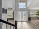Bright foyer with soaring ceilings, decorative glass doors, wood-look floors, and neutral color palette at 325 Green Ash Ln, Sanford, FL 32771