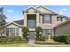 Attractive two-story home featuring stone accents, large windows, and well-maintained front yard with fountain at 325 Green Ash Ln, Sanford, FL 32771