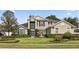 Inviting two-story home with stone accents, manicured lawn, fountain, and lush landscaping at 325 Green Ash Ln, Sanford, FL 32771
