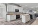 Well-equipped kitchen with white cabinets, a center island, and modern appliances at 325 Green Ash Ln, Sanford, FL 32771