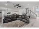 Open living room with hardwood floors, fan, stairs, and access to the kitchen and dining area at 325 Green Ash Ln, Sanford, FL 32771