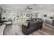 Spacious living area featuring hardwood floors and access to the kitchen and backyard at 325 Green Ash Ln, Sanford, FL 32771