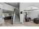 Open-concept living space with stairs, a sitting area, and open access to an adjoining room at 325 Green Ash Ln, Sanford, FL 32771