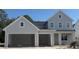 Charming two-story home with a two-car garage, showcasing a modern farmhouse design at 340 Ambersweet Pl, Lake Mary, FL 32746