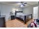 Bedroom showcasing a large bed, laminate floors, and ceiling fan, offering a comfortable and inviting space at 3822 Janie Ct, Orlando, FL 32822