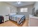 Bedroom with wood floors featuring a TV and full-sized bed at 3822 Janie Ct, Orlando, FL 32822