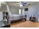 Bedroom featuring a queen bed, neutral gray walls, wood laminate flooring, ceiling fan and mounted TV at 3822 Janie Ct, Orlando, FL 32822