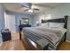 Bedroom with a large bed, laminate floors, and ceiling fan, offering a comfortable and inviting space at 3822 Janie Ct, Orlando, FL 32822