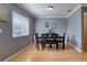 Sunlit dining area with neutral walls, wood floors, and simple decor at 3822 Janie Ct, Orlando, FL 32822