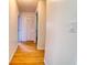 Hallway with wood flooring featuring a closet and leading to two door openings at 3822 Janie Ct, Orlando, FL 32822