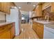 Well-lit kitchen provides access to living room and kitchen with warm cabinetry at 3822 Janie Ct, Orlando, FL 32822