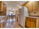 Charming kitchen with wooden cabinets and appliances, looking into sunlit breakfast nook at 3822 Janie Ct, Orlando, FL 32822