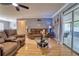 Cozy living room featuring plush seating, wood floors, and a sliding glass door to the patio at 3822 Janie Ct, Orlando, FL 32822