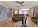Open living area with wood floors that connect to dining area, kitchen, and living room at 3822 Janie Ct, Orlando, FL 32822