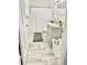 Neat bathroom with tile floors, white cabinets, single sink vanity, and shower-tub combo at 400 Palm Ave, Ormond Beach, FL 32174
