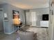 Cozy bedroom featuring a desk, chair, television, and a comfortable seating area at 400 Palm Ave, Ormond Beach, FL 32174