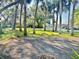 Expansive front yard features mature palm trees and a well-maintained grassy lawn at 400 Palm Ave, Ormond Beach, FL 32174