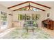 Bright and airy living room features a vaulted ceiling with exposed beams at 400 Palm Ave, Ormond Beach, FL 32174
