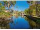 Stunning waterfront view along a tranquil canal, surrounded by lush greenery and docks at 400 Palm Ave, Ormond Beach, FL 32174