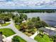 Aerial view of a waterfront home on a well manicured lot, with mature trees and direct access to a lake at 4030 Cool Water Ct, Winter Park, FL 32792